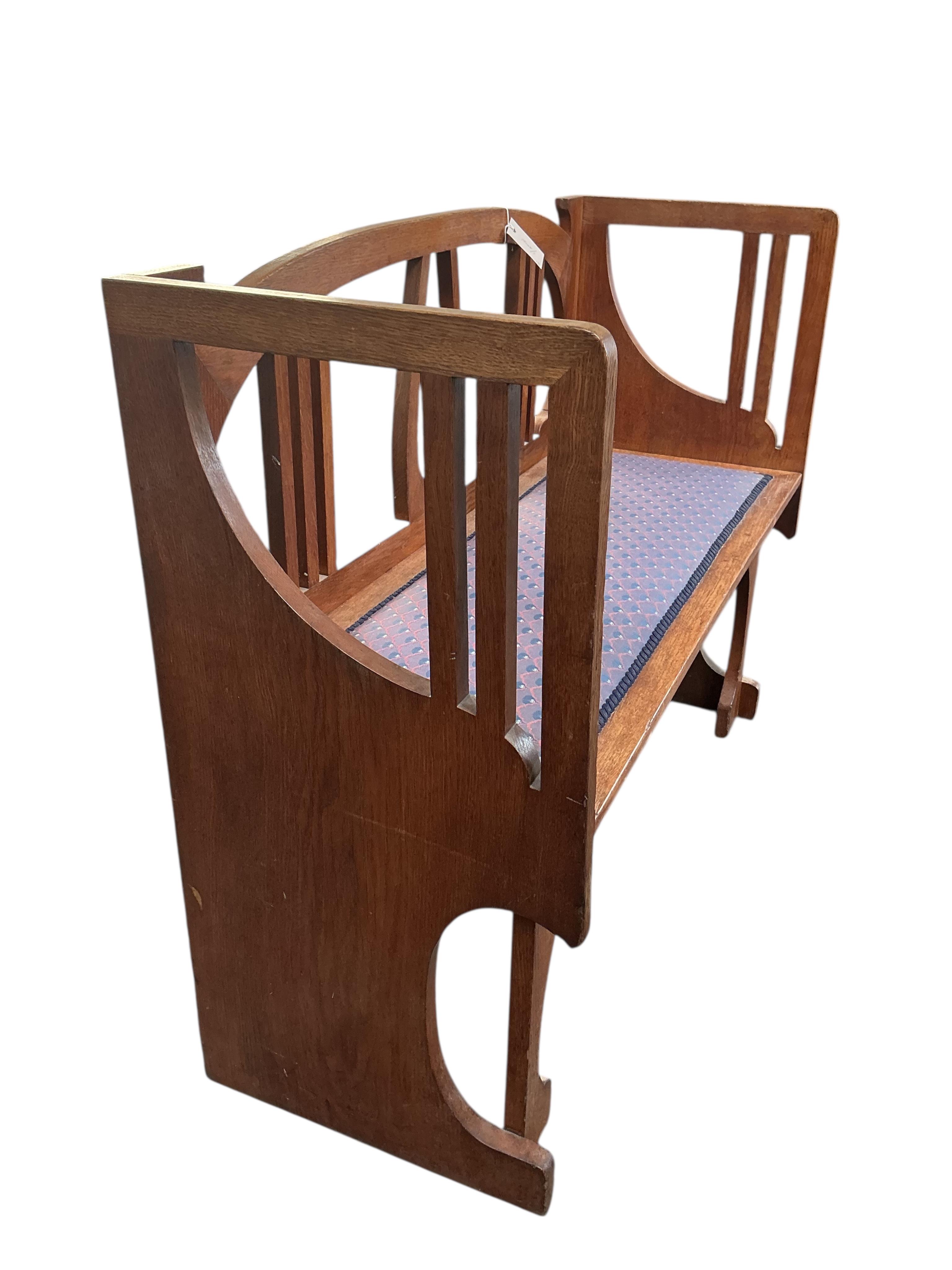 In the manner of Josef Hoffmann, an Art Nouveau oak chair-back settee and similar stool, settee width 110cm, depth 43cm, height 87cm.